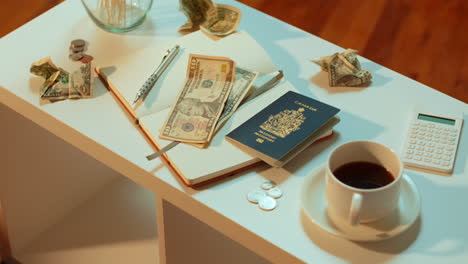 a caucasian woman takes her canadian passport off the coffee table