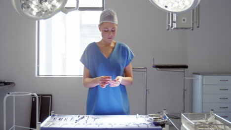 nurse arranging surgical tools on tray