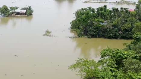 a rural flooded village with homes submerged by flood water. severe flooding. aerial view