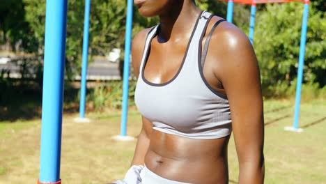 female athlete relaxing after workout in the park 4k