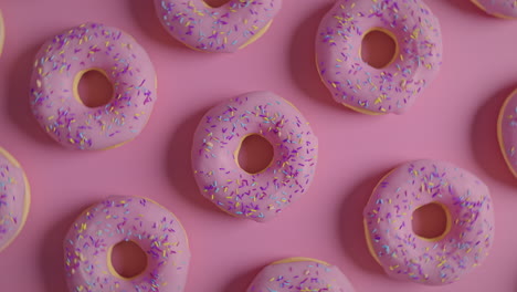 pink glaze donuts on a pink background
