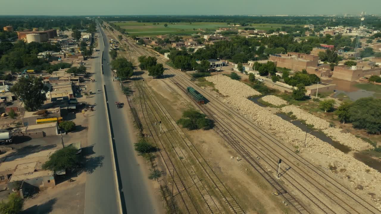 Sher Shah town connecting road and railway lines with a train passing through
