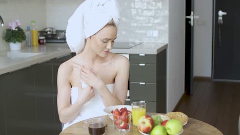 beautiful middle aged woman sitting in her kitchen in the morning