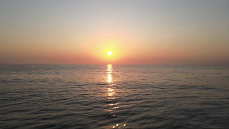 Aerial-Drone-Shot-of-a-Beautiful-Calm-Sunrise-Over-the-Gulf-of-Thailand-with-Reflection