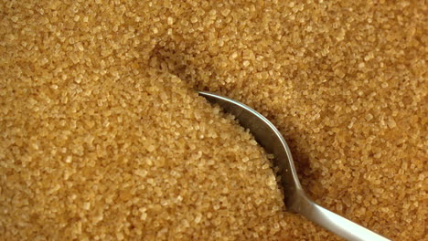 Teaspoon-scooping-up-golden-sugar