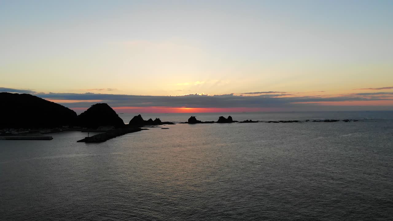 Golden Sunset over Coastal Rock Formations and Ocean