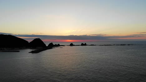 golden sunset over coastal rock formations and ocean