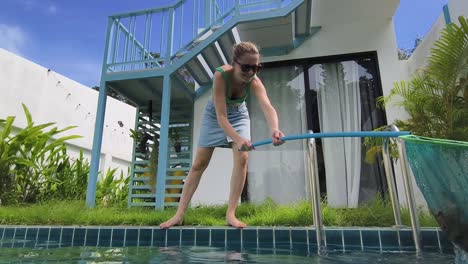 woman cleaning a pool