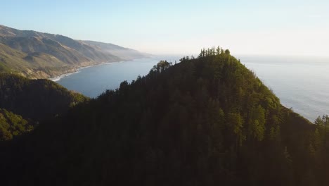 drone shot of mountains, forest and ocean in big sur, california