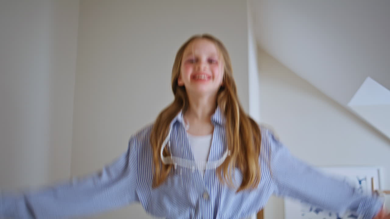 Carefree toddler jumping bed having fun morning sunlight closeup. Kid rejoicing