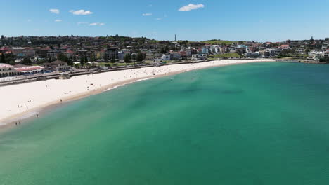 bondi beach with blue sky and turquoise ocean in sydney, australia - aerial drone shot