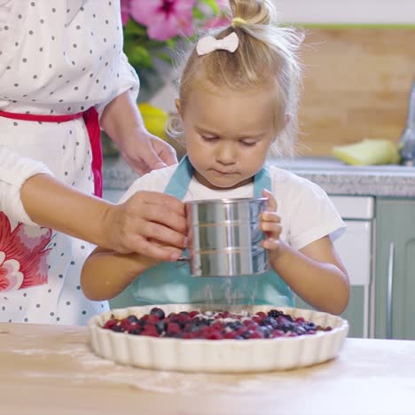 mother teaching her cute little daughter to bake