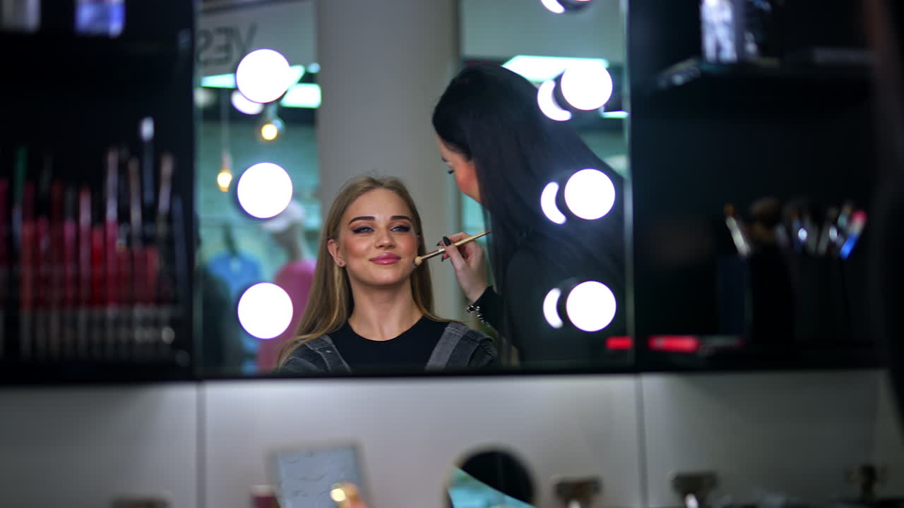 artista de maquillaje aplicando maquillaje a una mujer
