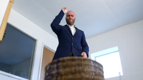 a business man is throwing away a paper document in to a waste paper bin basket after receiving bad news