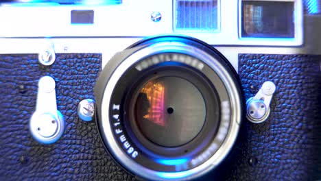 old camera show, blue tint light on vintage film camera, background 4k footage