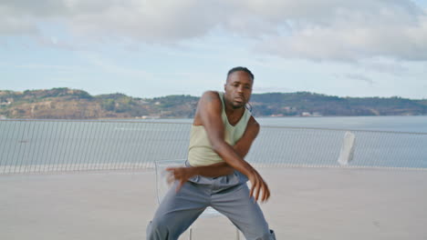 vertical ballet man performing sea view portrait. fashion dancer guy solo dance