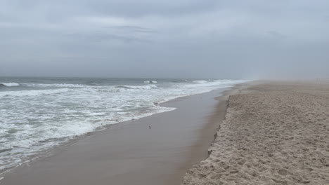 waves slowly eroding a worcester county beach as a storm approaches.
