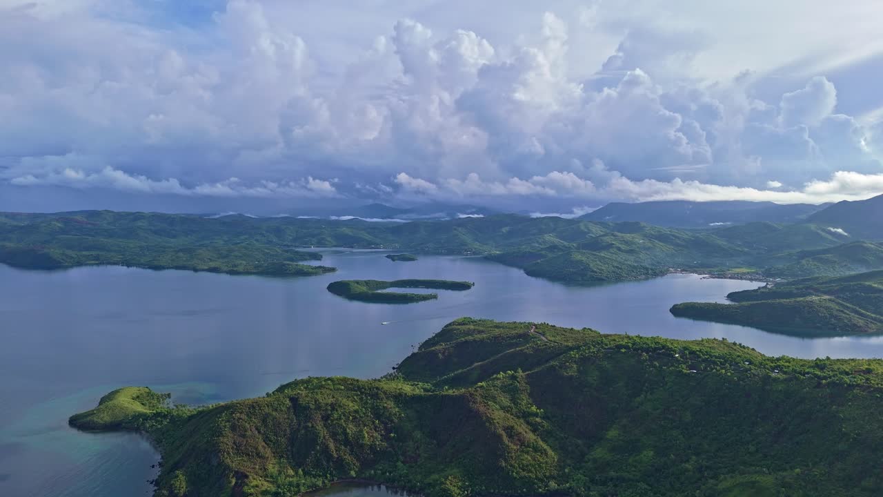 Aerial shot of a boat sailing through the Letye Gulf with vast mountains