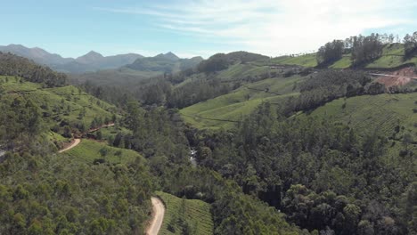 4k-drone-footage-of-the-a-vast-valley-of-the-Western-Ghats-mountain-range-near-the-countryside-tea-plantation-town-of-Munnar,-India