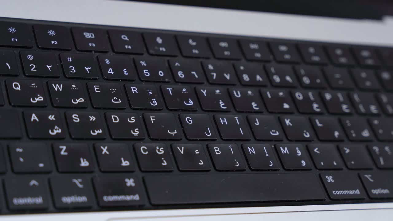 Sharp macro of bilingual Arabic-English keyboard—ideal for tech, language, or digital workspace content.