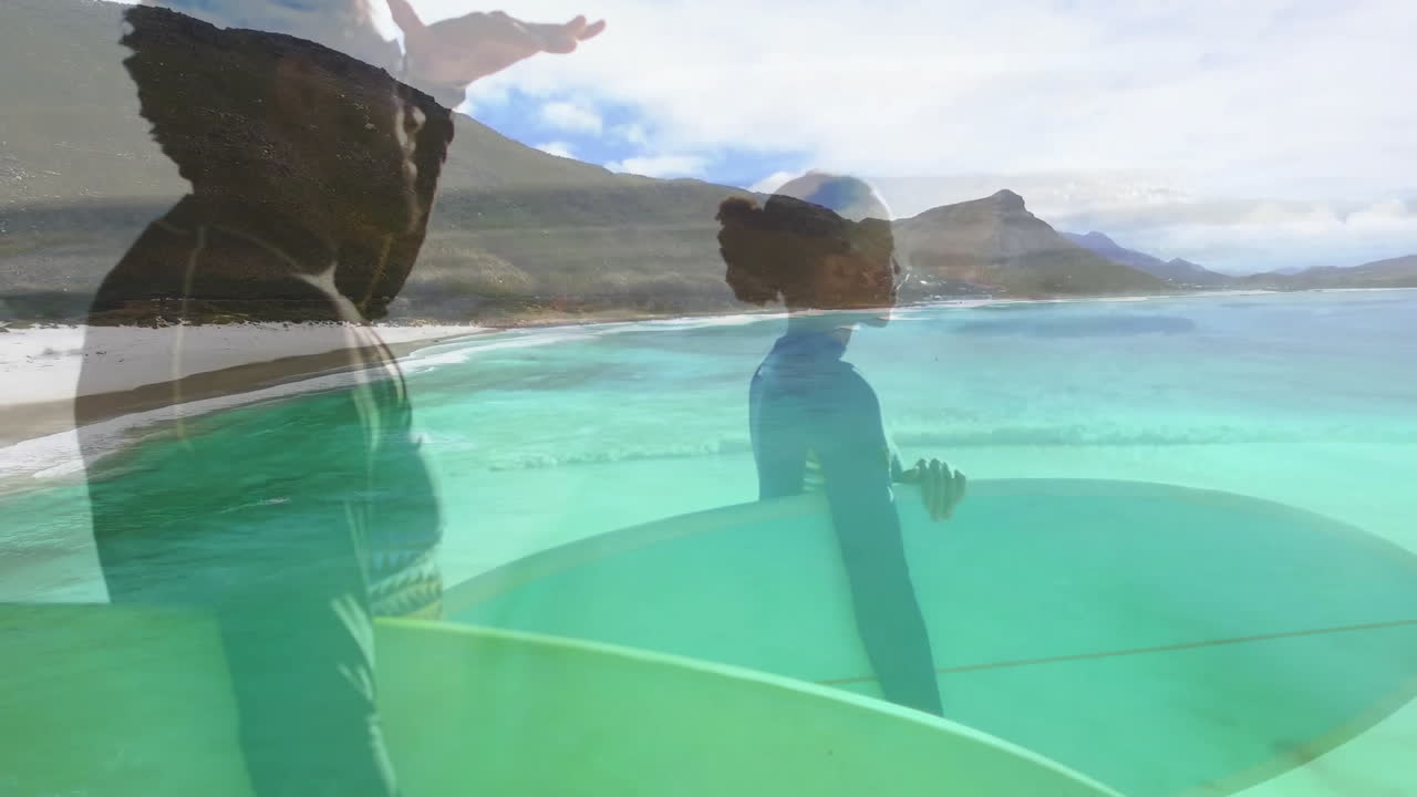 Surfers holding surfboards in shallow water, showing animated technology wave chart with ocean data