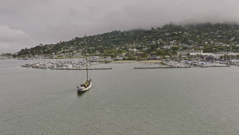 Sausalito-City-California-Aerial-v5-flyover-richardson-bay-towards-dunphy-park-capturing-yachts-and-boats-docked-at-marinas-and-hillside-residential-neighborhood---Shot-with-Mavic-3-Cine---June-2022