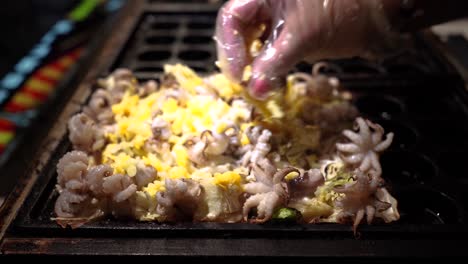 chef cooking takoyaki in night market