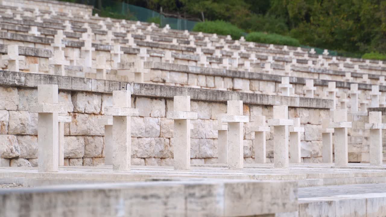 Rows of white small simple stone crosses on hillside at Polish cemetery at Monte Cassino, Italy, static