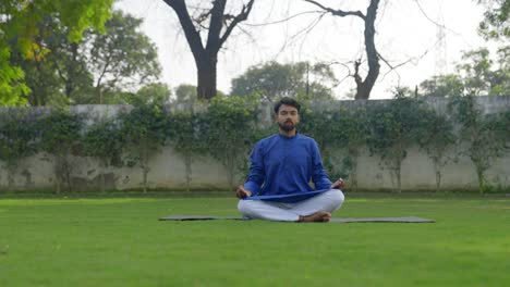 indian man doing pranayam yoga