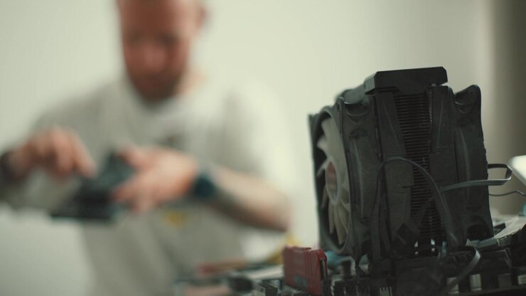 Technician repairing computer cpu cooler fan