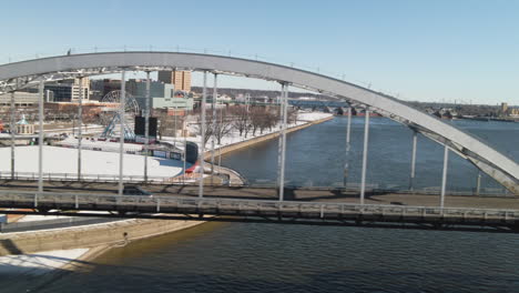 cars passing over a downtown bridge over the mississippi river in davenport, iowa