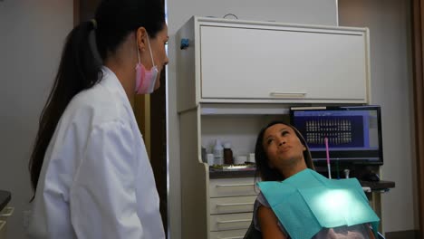 female dentist interacting with patient 4k