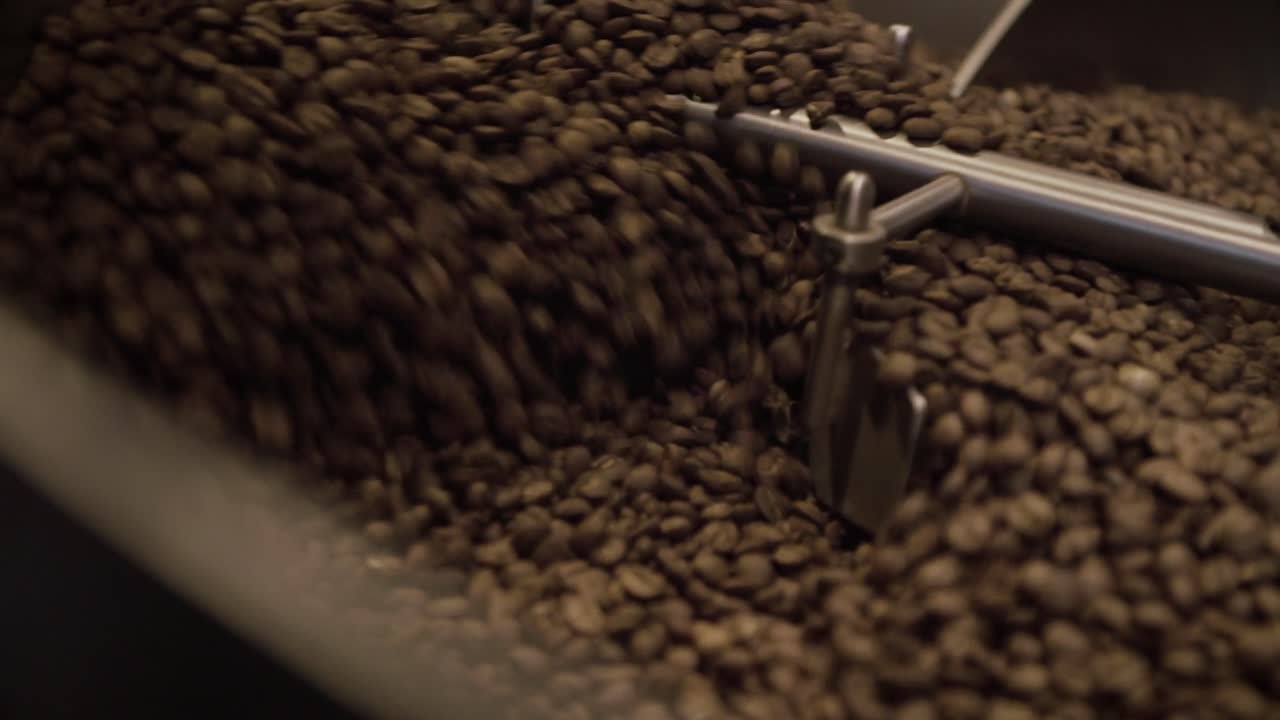 Coffee beans are being mixed in a large machine