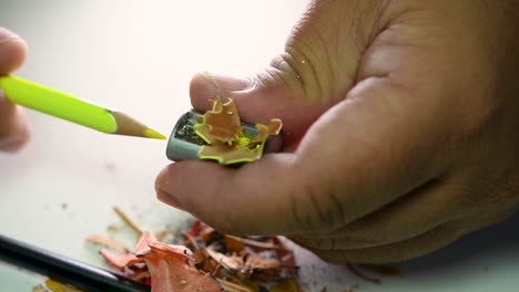 Footage-of-hands-slowly-sharpening-a-pencil-and-some-coloured-pencils-with-a-Wedge-Pencil-Sharpener