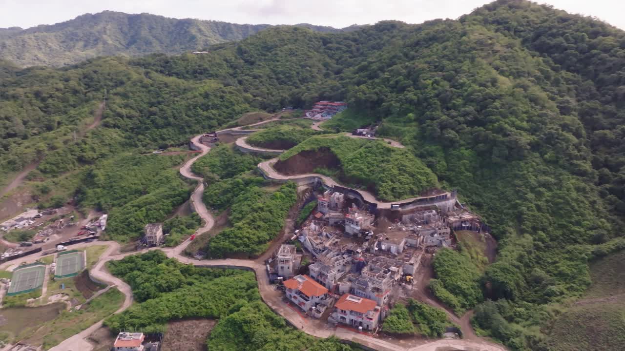 Las Catalinas, Guanacaste Province in Costa Rica showing homes, mountains and ocean with drone video moving panning right to left