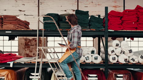 tablet, leather workshop and man on ladder