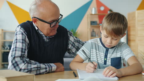 grandfather helping grandson with homework