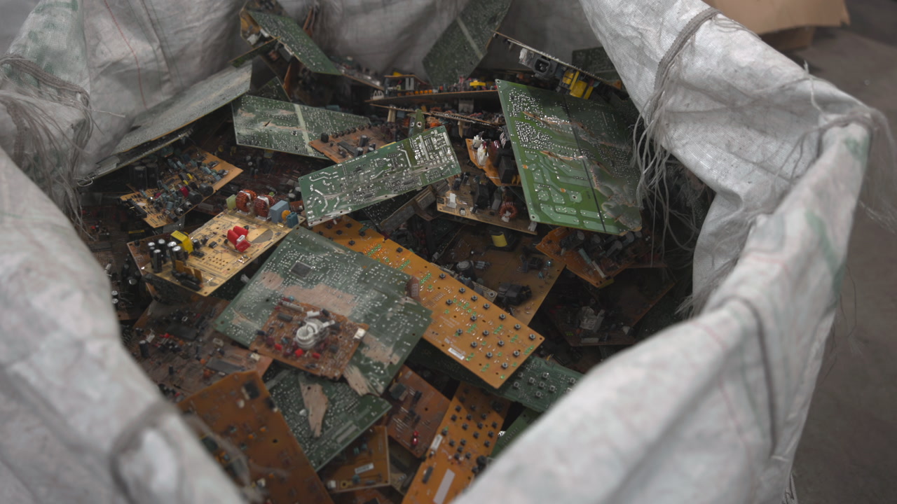 Large Bag Of Circuit Boards Shows Mixed Electronic Scrap, Oxidized Solder, Broken Components, Layered Green . Media