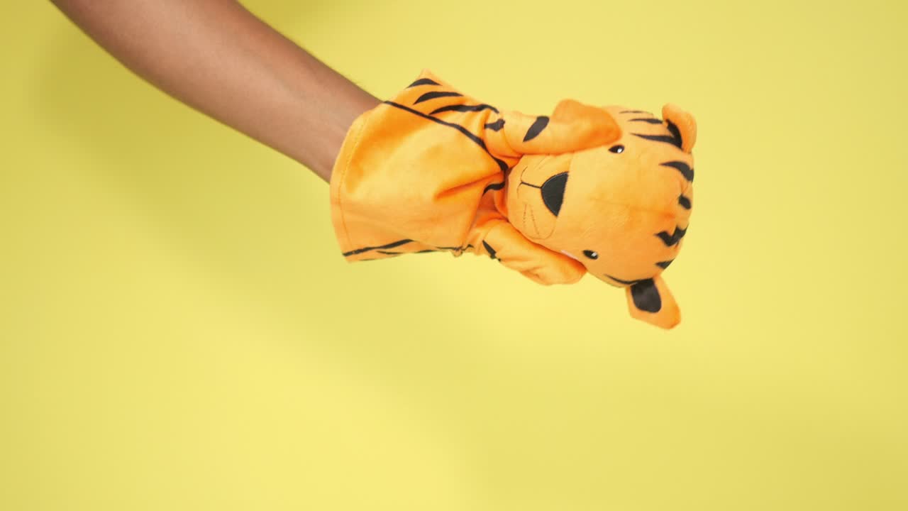 Tiger puppet on a yellow background
