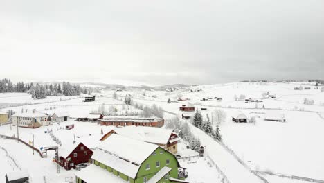 A-beautiful-aerial-shoot-over-a-snowy-village-in-the-mountains-of-Romania