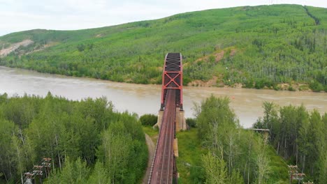 4K-Drone-Video-of-Mears-Memorial-Steel-Truss-Train-Bridge-over-the-Tanana-River-at-Nenana,-Alaska-during-Summer-Day