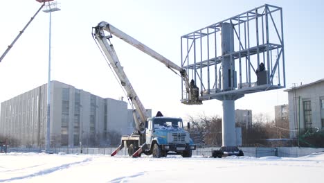 installing a large billboard in the winter