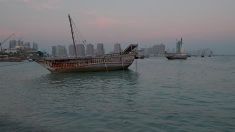 dhows with qatar flag in arabic gulf in katara cultural village, doha, qatar