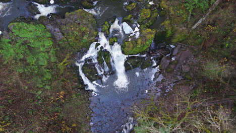 4K-drone-footage-flying-above-small-waterfalls-in-forest