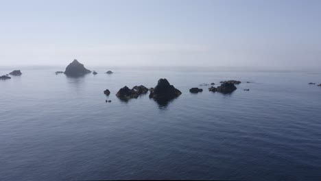 small jagged rocks in shallow ocean water present navigation hazard