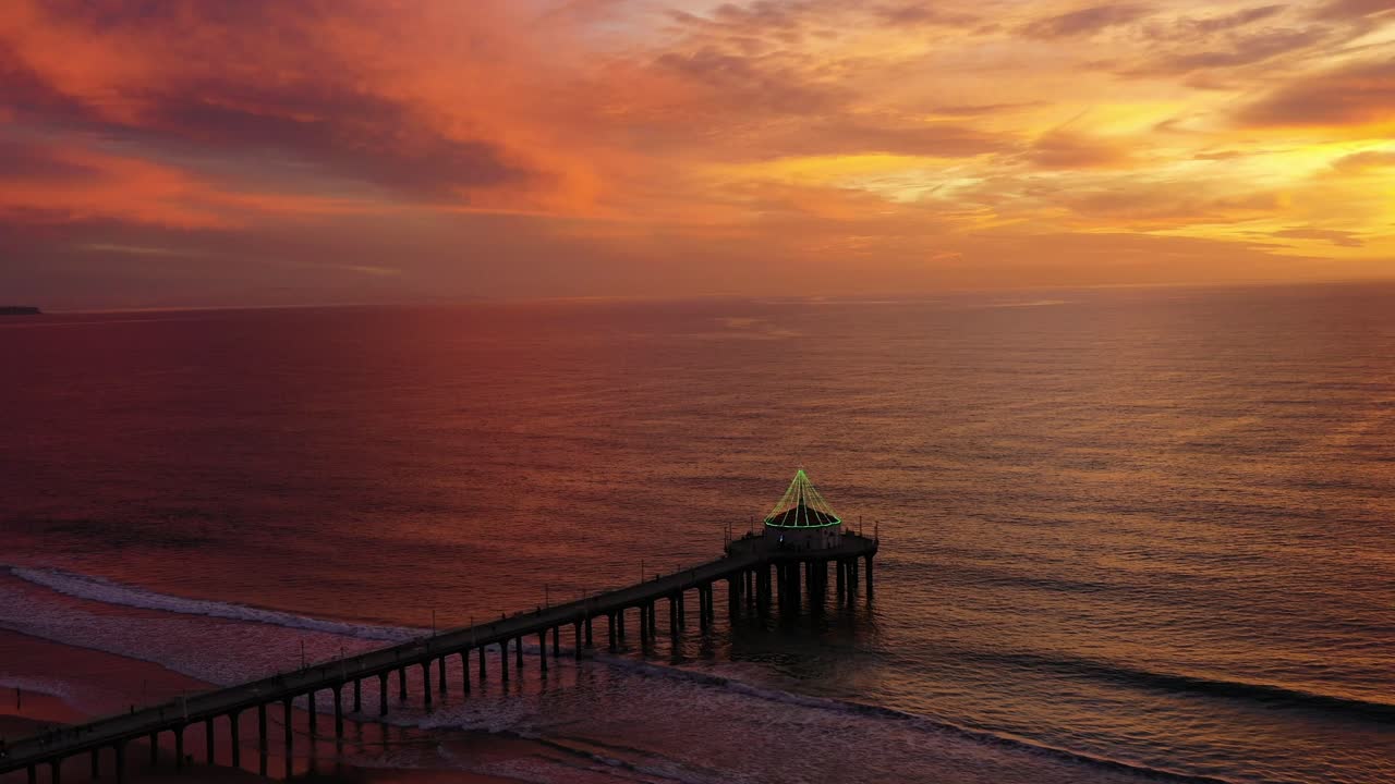 Dramatic Sunset Sky Over Manhattan Beach Pier In California - aerial drone shot
