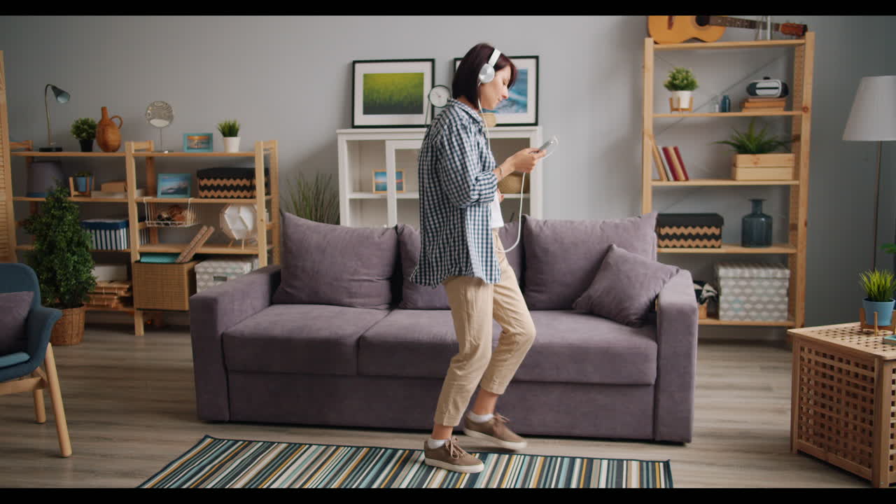 Woman Dancing to Music in Living Room