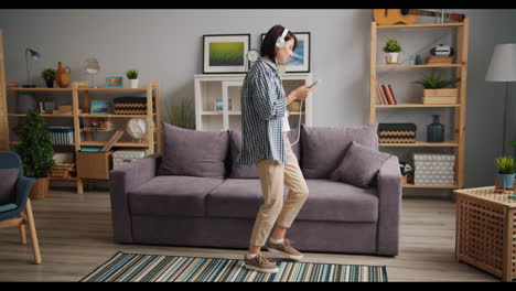 woman dancing to music in living room