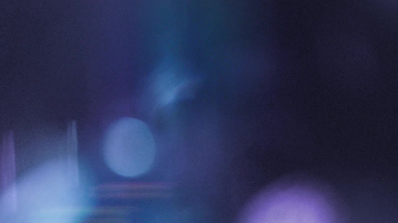 Moving Blue and Purple Light Leaks with Grainy Bokeh Effect
