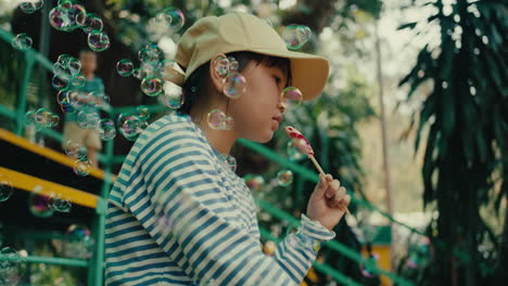 girl eating lollipop in a park